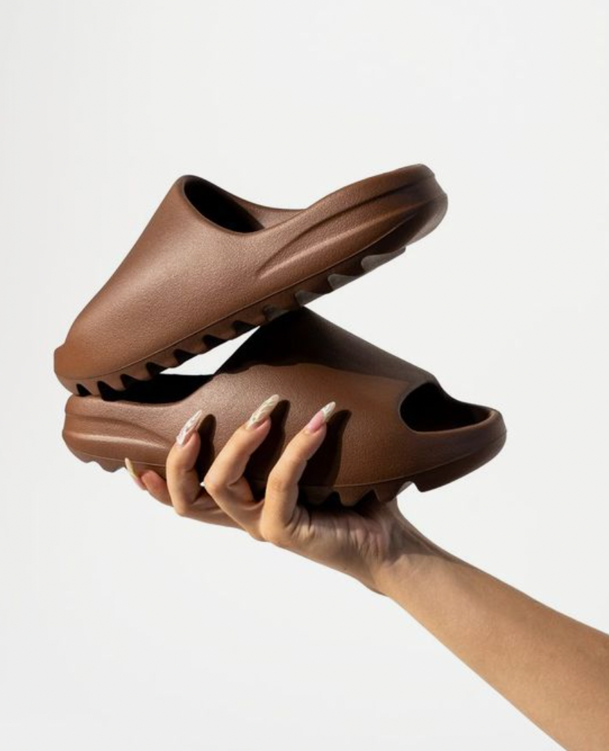 earth brown yeezy slides on feet